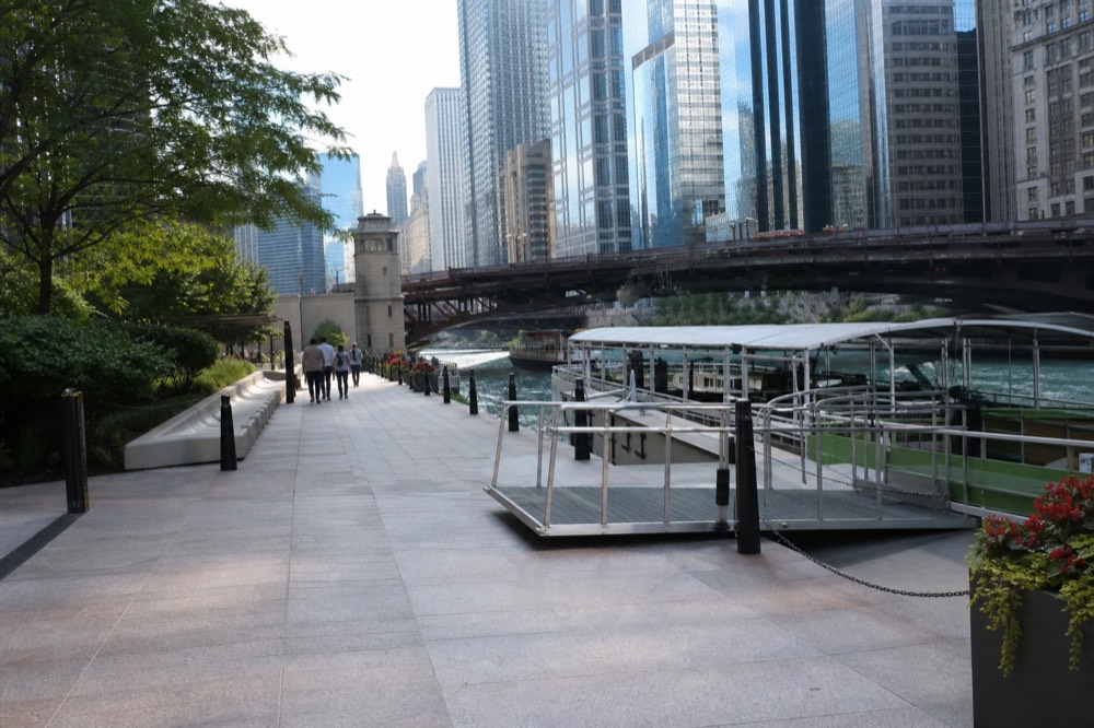A Chicago River tour boat passing downtown towers, no text, no logos, no people.
